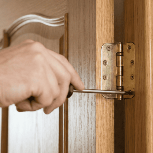 Handyman in Adelaide repairing a door